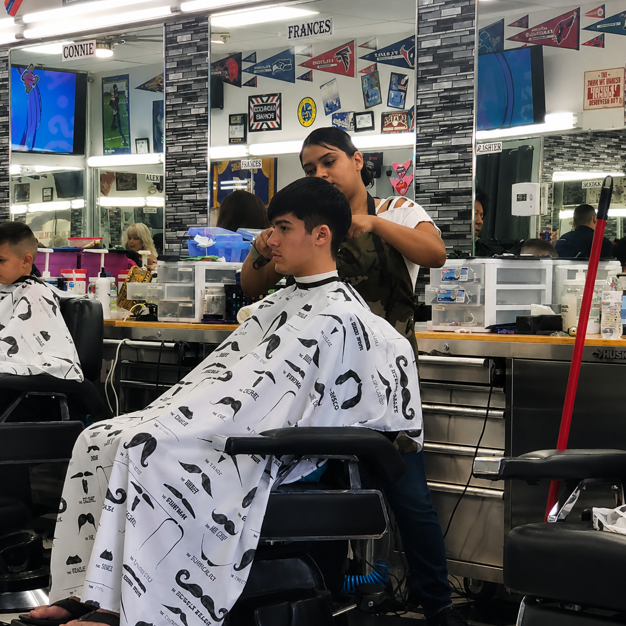 Barber cutting a client's hair inside Carlos' Barber Shop 2 in Riverside